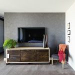 Wall mounted tv and buffet in spacious master bedroom with decor items