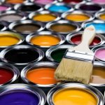 Tin cans with paint, brushes and bright palette of colors