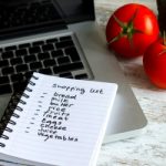 Preparing the shopping list before going to buy the groceries.