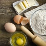 Ingredients for baking on the old wooden table, top view, copy space