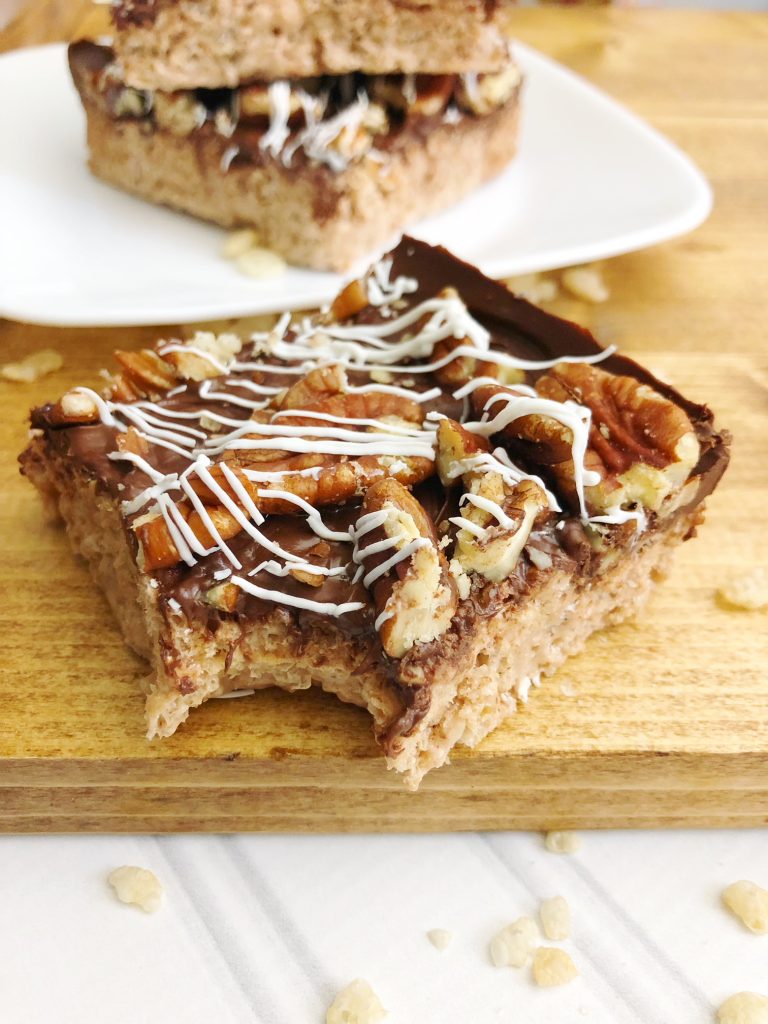 triple chocolate Rice Krispie bars on the wooden board