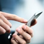 Close up of a man using mobile smart phone
