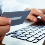 Man using laptop for online shopping in close up
